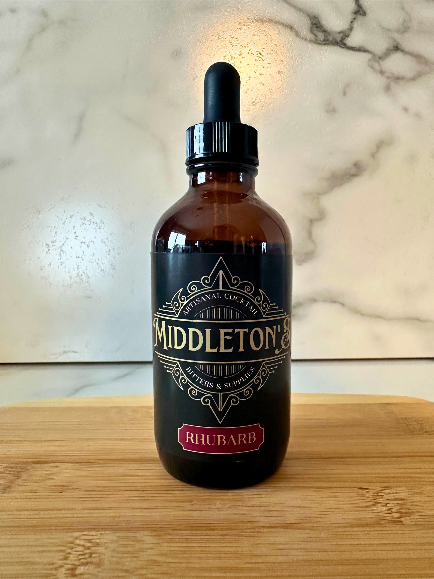 4oz bottle of Middleton's Rhubarb Bitters with distinctive label showing handcrafted artisanal bitters for cocktails and culinary uses
