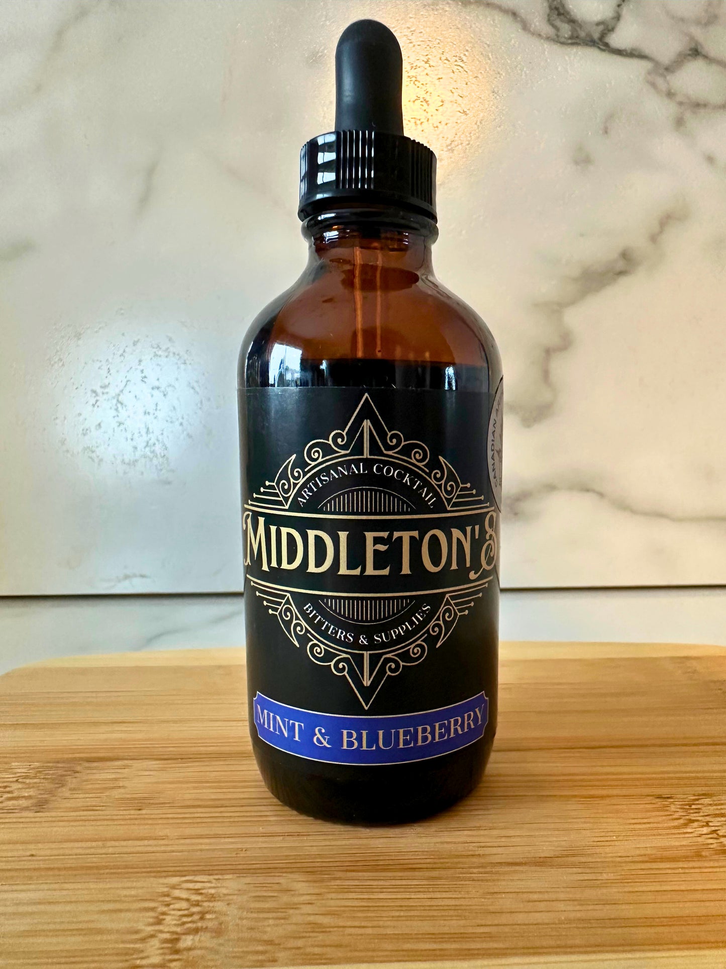 Middleton's Mint & Blueberry Bitters - 4oz bottle with fresh mint leaves and blueberries
