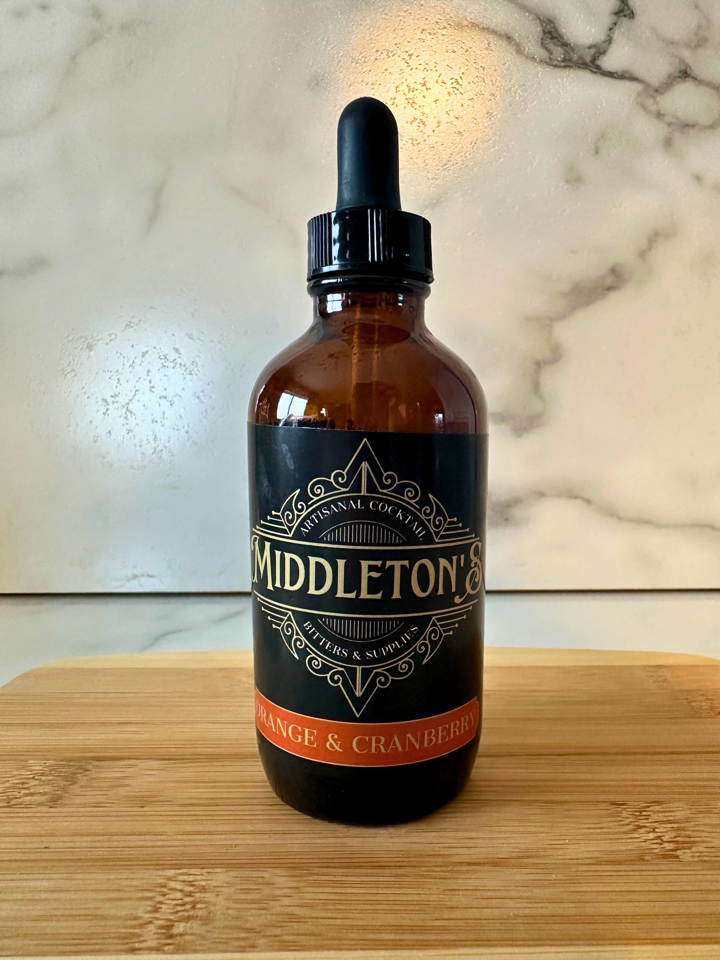 Bottle of Middleton's Orange & Cranberry Bitters with bright citrus and berry colors