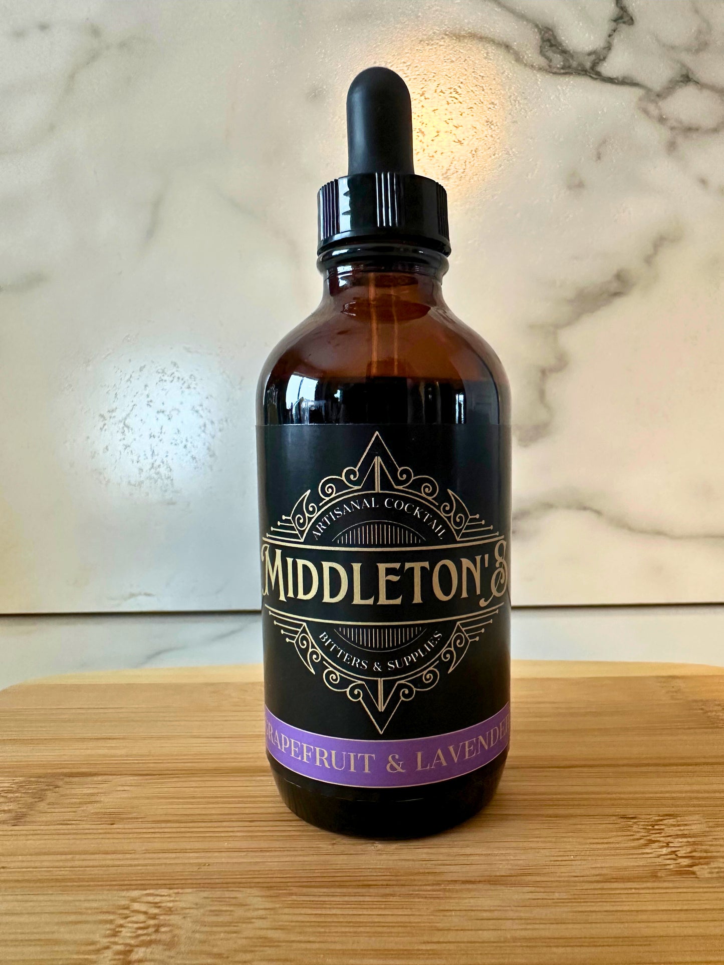 4oz bottle of Middleton's Grapefruit & Lavender Bitters with bright citrus and floral design